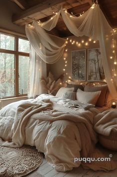 a bed with white sheets and lights hanging from the ceiling in a room filled with windows