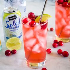 two glasses filled with cranberry lemonade and garnished with cherries