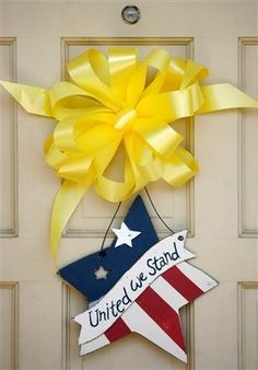 a patriotic door hanger with the words united we stand and an american flag star