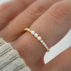 Beautiful pave band with three dainty pearls. So dainty and chic, it looks so cute on its own or stacked with other rings! Made of 925 Sterling Silver We use a THICK, DURABLE plating of 14K Gold, Rose Gold or Rhodium - for a piece that will last you years to come! Nickel-free & Hypoallergenic Width: 2mm Simple Pearl Ring Silver, Dainty Silver Jewelry Rings, 3 Pearl Ring, Simple Band Rings, Dainty Gold Ring Stack, Dainty Pearl Ring, Pretty Gold Jewelry, Pearl Rings In Silver, Prom Jewlrey