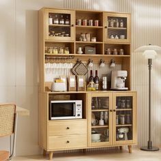 a kitchen area with a microwave, counter top and wooden shelves filled with food items