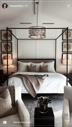 a bedroom with a four poster bed and white furniture