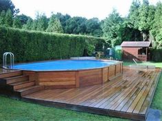 an above ground pool surrounded by wooden decking