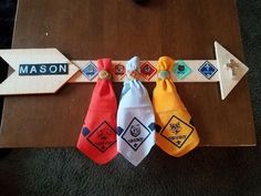 three ties are tied together on a table with name tags and magnets attached to them