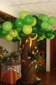 a balloon tree with green and yellow balloons