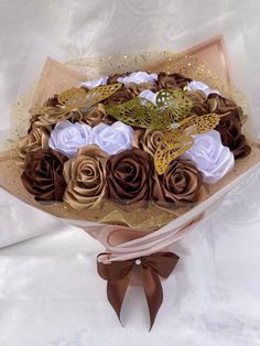 a bouquet of flowers with brown and white roses