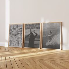 three framed pictures on the wall in an empty room with wood flooring and white walls