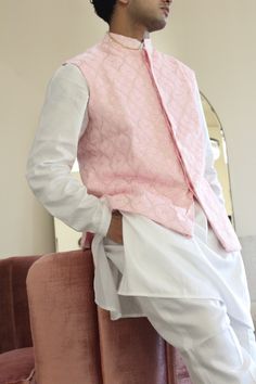 Meet Shehzaan! This is a complete 3-piece mens set perfect for any Indian event you need to attend. Features a blush pink vest on georgette base with floral and machine embroidery. Paired with a white kurta set. Looks good on its own or paired with any vest in your closet. Kurta, vest, and pants included. Designer Pink Bandhgala With Resham Embroidery, Pink Nehru Jacket With Zari Work For Spring, Spring Pink Nehru Jacket With Zari Work, Designer Pink Nehru Jacket With Zari Work, Festive Pink Designer Bandhgala, Traditional Spring Nehru Jacket With Dabka, Designer Pink Kurta With Resham Embroidery, Unstitched Spring Wedding Sherwani, Designer Spring Wedding Kurta