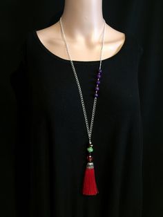 Long silver chain necklace with red silk tassel. I have added multi color crystals to this removable tassel. Pop this tassel onto any of your other necklaces. Purple howlite beads make this chain stand out. I have finished this adjustable length necklace with a tiny bright green bead. There is only one of these necklaces, so don't dither! FREE SHIPPING! Here is a link to my whole shop: https://etsy.me/2JLBfHp JUST FOR YOU Lots of my items can be customized. Lengths can usually be altered; earrin Red Tassel Necklaces For Gifts, Red Tassel Necklaces As Gifts, Red Tassel Necklace For Gift, Red Tassel Jewelry With Round Beads, Red Round Beads Jewelry With Tassels, Red Jewelry With Tassels And Round Beads, Necklaces Purple, Long Tassel Necklace, Length Necklace