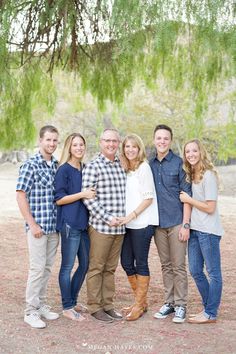 a family posing for a photo under a tree