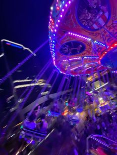 a carnival ride at night with people on it