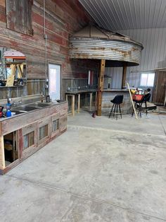 the inside of a building that is being remodeled with wood and metal fixtures on the walls