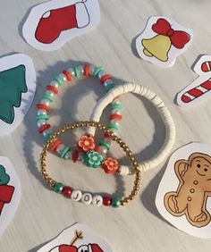 several bracelets with christmas decorations and stickers on the table in front of them