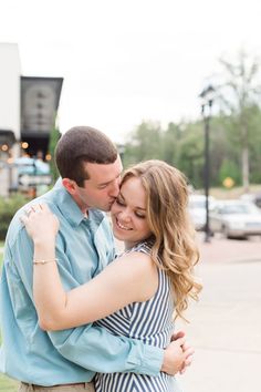 a young man and woman embracing each other