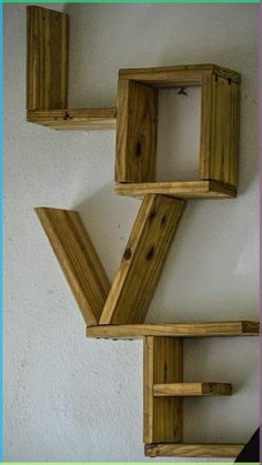 three wooden shelves are stacked on top of each other in the shape of letter v