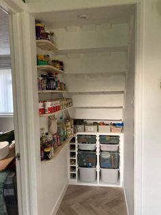 an empty pantry is shown with shelves and bins full of food, along with other items