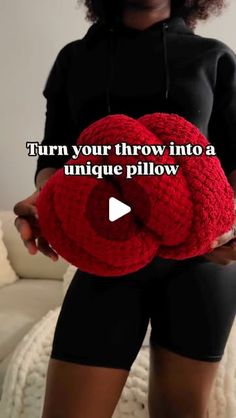 a woman holding a red crochet pillow with the words turn your throw into a unique pillow