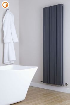 a white bath tub sitting next to a radiator