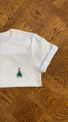 Hand Embroidered T-Shirt Christmas White Embroidered Tops, White Tops With Custom Embroidery For Christmas, White Christmas Tops With Embroidered Graphics, White Tops With Embroidered Logo For Christmas, White Top With Embroidered Logo For Christmas, White T-shirt With Machine Embroidery, Short Sleeve, White Short Sleeve Tops With Machine Embroidery, White Embroidered Crew Neck Shirt, White Crew Neck Tops With Machine Embroidery