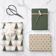 christmas wrapping supplies laid out on a marble surface