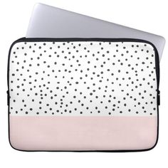 a laptop computer case with polka dots on white and light pink, the cover is open