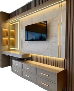 an entertainment center with cabinets and a flat screen tv mounted on the wall above it