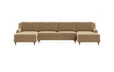 a beige sectional couch with wooden legs and footrests on an isolated white background