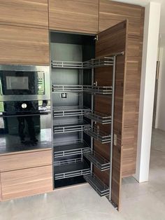 an open cabinet in the middle of a kitchen