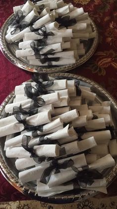 two plates with black and white napkins on them