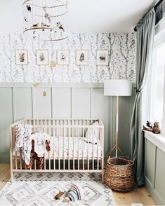 a baby's room with a crib, rug and wallpaper