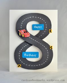 a handmade birthday card with a car on the road and happy 8 in the middle