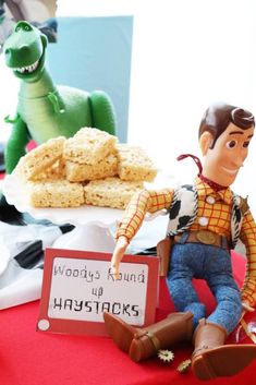 toy figurines sitting on top of a table next to cookies and crackers