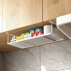 a kitchen shelf that has various items on it and is hanging from the ceiling above