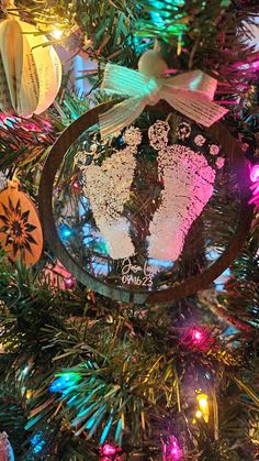 an ornament hanging from the top of a christmas tree