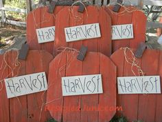 four pumpkins with the words happy harvest written on them are sitting in front of a fence