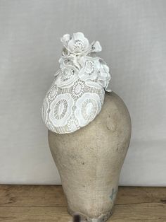 White Crochet Lace Percher Hat with Lace Flowers and Pearls  Striking piece could be used as a bridal headpiece Can sit to either side of the head and is held on with a hat elastic it can be put on a headband if you prefer Ready to wear in White, can be made in other colours - please message me to discuss Great for events such as a wedding, race meetings such as Royal Ascot, Cheltenham, Ebor, Goodwood, Melbourne Cup, Kentucky Derby or any hat wearing occasion.  Completely hand blocked and hand stitched. Fitted White Headpiece For Ceremony, White Hat For Royal Ascot Ceremony, White Fitted Ceremony Headpieces, White Hat For Kentucky Derby Ceremony, Fitted White Ceremony Headpiece, White Mini Hat For Kentucky Derby Ceremony, White Mini Hats For Kentucky Derby Ceremonies, Adjustable Cloche Headpiece For Church, Fitted Round Crown Headpiece For Weddings