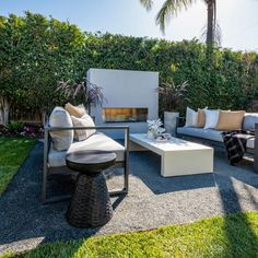 an outdoor living area with couches and tables