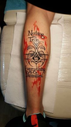 a person with a tattoo on their leg that says nothing true is ever coming permitted