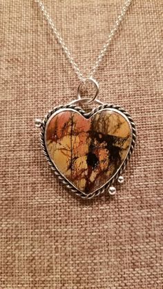 This Picasso Jasper Heart is Handmade by me in my studio. I use only hand tools to make my jewelry. I start with Sheet Metal and wire that's real Sterling Silver not plated metal and only use natural minerals and gemstones.  If you're looking for a One of a Kind Pendant to complete your look or for a special gift , you'll love this beautiful jasper pendant.  💟 Material Details: ---100% Handmade Sterling/Fine Silver Bezel Setting, Twisted Wire, Jump Rings, Bail and Granules --- 1.75 x1.75 inch Hand cut and hand polished Heart shaped Natural Picasso Jasper Mineral, --- Blackening Patina --- Your choice of : 22, 24, 26 inch long commercial .925 Sterling Silver chain --- Round Spring Locking catch 💟 The GOLDSMITH TECHNIQUES I may have USED: alloying,forging, Designing, Milling, Forming, Cutt Artisan Heart Shaped Jewelry For Crafting, Unique Hand Forged Heart Pendant, Unique Hand Forged Heart-shaped Jewelry, Unique Hand Forged Heart Pendant Jewelry, Artisan Heart-shaped Jewelry For Anniversary, Unique Wire Wrapped Heart Pendant Jewelry, Nature-inspired Heart Shaped Jewelry Gift, Unique Handmade Heart-shaped Jewelry, Unique Handmade Heart Pendant Jewelry