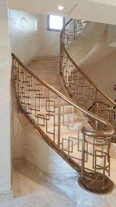 a stair case in the middle of a room with white walls and flooring on it