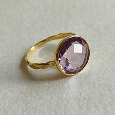 ITEM DESCRIPTION: >> The Ring is made from Solid 14K Yellow Gold. Gemstone used is absolutely natural and ethically sourced.  >> Natural Pink Amethyst in round shape briollette cut and bezel setting is studded on it with utmost precision.  Gem: Pink Amethyst  Gem size: 12 mm & Round   Gem weight: 4.90 carats Gold purity: 14K (58.33% approx.) Gold weight: 1.50 grams  Gross weight : 2.48 grams The Gold purity is guaranteed and it comes with authentic 14K gold hallmark. Since these Rings are handma Luxury Purple Ring With Bezel Setting, Faceted Amethyst Ring In Yellow Gold Fine Jewelry, Elegant Faceted Amethyst Ring In Yellow Gold, Purple Sapphire Ring In 14k Gold For Wedding, Gold Faceted Amethyst Ring, Elegant Gold Faceted Amethyst Ring, Elegant Gold Amethyst Ring With Faceted Detail, Elegant Gold Amethyst Ring With Faceted Cut, Luxury Lavender Amethyst Ring For Gift