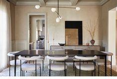 a dining room table with white chairs around it