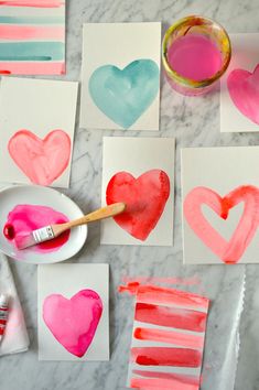 valentine's day crafts for kids with watercolors and paper hearts on the table