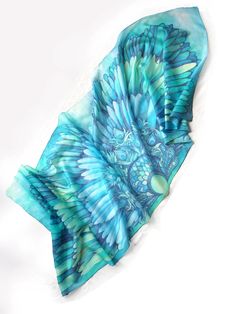 Ocean Blue Wings is a turquoise silk scarves hand painted with bird motif and feathers making a perfect bohemian wedding veil. Think about boho shawl for the bride! Size: 23 by 70 inches (177 by 60 centieters) Silk: pure Habotai Light, semi transparent and a bit glossy. This Wings scarf was designed and hand painted by me as an fashion statement wearable piece of art. The shawl can become a wedding blue veil or a beach pareo or a gorgeous every day scarves. The Blue Wings silk scarf is made to o Blue Bohemian Shawl For Summer, Bohemian Blue Shawl For Weddings, Bohemian Blue Silk Scarf Gift, Bohemian Blue Silk Scarf As Gift, Bohemian Blue Silk Scarf For Gift, Bohemian Handmade Silk Scarves, Handmade Silk Bohemian Scarves, Handmade Silk Bohemian Scarf, Handmade Silk Bohemian Shawl