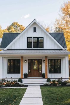 a white house with black roof and windows