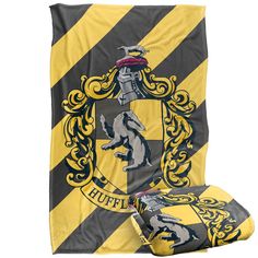 a harry potter blanket and pillow set with the hogwarts crest on it's side