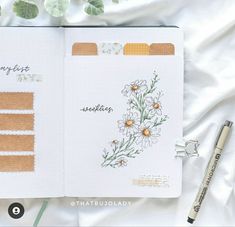 an open planner book with flowers on it