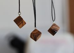 Playful wood pendants with inlay. Made from beautiful olive tree. Perfect gift fot people who loves natural jewelry. Each pendant is different because of the pattern of the wood.  Wood: olive tree Dimentions: ~1.8 cm () Option 1 Inlay: Brass mandala style Cord: Brown cotton Cord length: 40 cm + 4 cm chain (15.75 + 1.6 inches) Option 2 Inlay: Metal alloy Cord: Black cotton  Cord length: 47 cm + 4 cm chain (18.5 + 1.6 inches) Option 3 Inlay: Metal alloy Cord: Grey cotton Cord length: 46 cm + 4 cm chain (18.1 + 1.6 inches) If you need different cord length message me.  *Do not wear while showering, swiming or in any other contact with water. Wood Pendants, Wood Cube, Cube Pendant, Wooden Cubes, Square Necklace, Natural Jewelry, Wooden Necklace, Love Natural, Wood Pendant