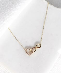 14K Gold Heart and Infinity Symbol Necklace A symbol of infinite love, this elegant necklace showcases the symbols of love and eternity entwined with each other. The heart motif perfectly complements the infinity symbol for a truly romantic look. This unique necklace is perfect for everyday wear as it is made of solid gold and won't tarnish. It is a wonderful gift for a special person. Features: * This necklace is made of patented 14K solid gold. * Length: 42 cm Packaging: You will get your jewe Elegant Heart Necklace With Adjustable Chain For Anniversary, Diamond Infinity Necklace For Gift, Infinity Jewelry With Diamond Accents For Gift, Rose Gold Infinity Necklace For Anniversary, Infinity Necklace With Diamond Accents For Gifts, Sterling Silver Infinity Necklace Fine Jewelry, Cubic Zirconia Infinity Necklace For Anniversary, Infinity Necklace For Anniversary Gift, Infinity Shaped Jewelry With Diamond Accents For Mother's Day