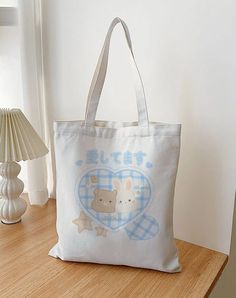 🐇 Cute cotton tote bag with bunny and bear heart design. Perfect for everyday use combining functionality and style! MATERIAL Bag and handles are made from 100% cotton fabric that is highly durable and perfect for everyday use. SIZE Width: 15.0 in (38.0 cm) Height: 16.5 in (42.0 cm) Handle width: 0.8 in (2.0 cm) Handle height: 12.2 in (31.0 cm) 💙 If you want to see more cute and fashionable products like this check out my Etsy shop DazzlMeShop: https://dazzlmeshop.etsy.com Cute School Bag With Bunny Design, Kawaii Cotton School Bags, Cute Everyday Beige Canvas Bag, Cute Cotton Bag With Large Capacity, Kawaii Cotton Canvas Bag For Daily Use, White Kawaii Canvas Bag For Everyday, White Kawaii Canvas Bag, Everyday White Kawaii Canvas Bag, Cute Cotton Canvas Bag For Daily Use